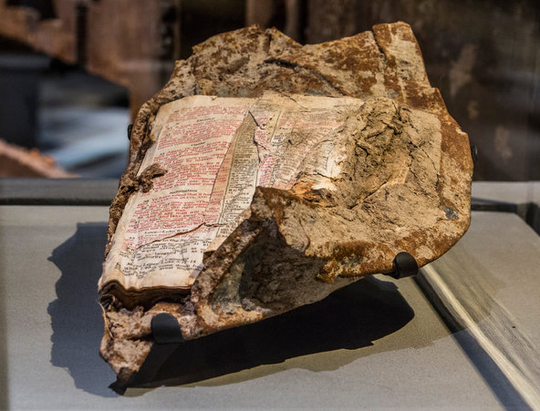 The damaged Ground Zero Bible fused to a piece of steel and displayed at the National September 11 Memorial & Museum