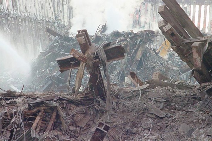 The cross-shaped intersecting steel columns standing amid the wreckage at Ground Zero